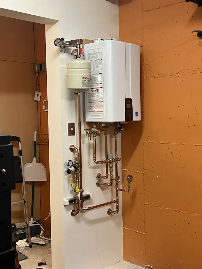 Plumbing technician inspecting water heater connections in Hillcrest Heights